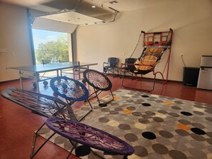 Game room across the street with ping pong, pool, basketball, foosball, and TV