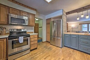 Well-stocked kitchen with coffee station adjacent. 