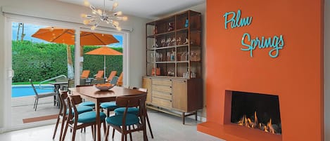 Fun dining room with vibrant gas fireplace and vintage buffet/bar