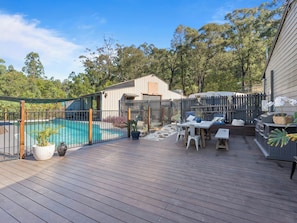 Outdoor bbq area with pool and dining table