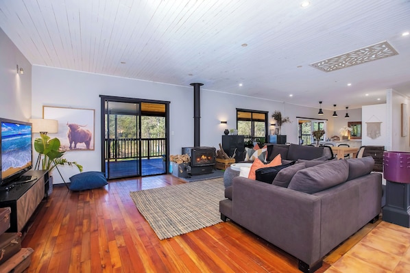 Living area with large fireplace and flat screen tv