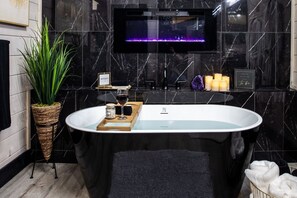 Gypsy Moon Black Soaker Tub and fireplace