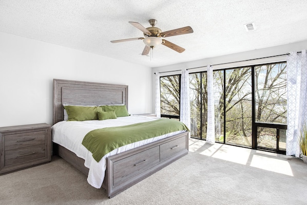 Your king suite hosts a wall of windows with natural views reaching to the lake.