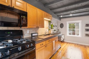 Experience culinary delight: Discover the fully-equipped galley kitchen in our charming abode.