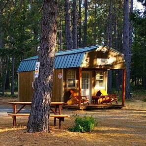 The cabin has a covered patio with chairs, a barbecue grill, and a private picnic table. You can relax and enjoy the stunning views of the forest, the mountains and sit by or swim in our freshwater swimming pond. The cabin is conveniently located where you can go fishing, rafting, kayaking, or hiking. 