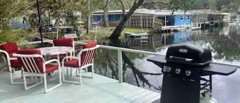 Waterfront deck with table and gas grill