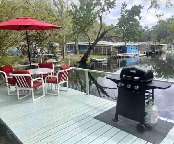 Waterfront deck with table and gas grill