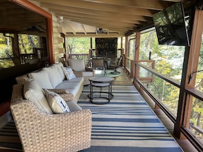 Outdoor seating with fireplace and 2 tvs