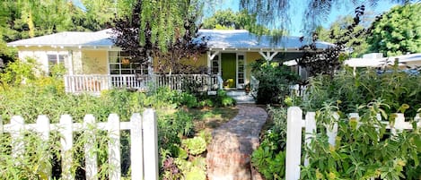 beautiful gardens, tree-lined street, walkable neighborhood.