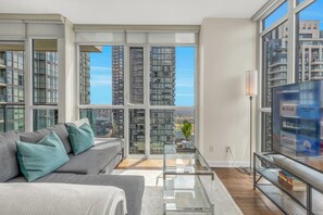 Living area with Queen size sofa bed and a 63” Smart TV 