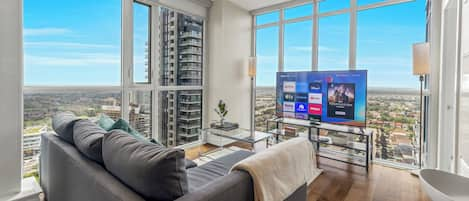 Living room with a 63” Smart TV and striking unobstructed views of Lake Ontario 