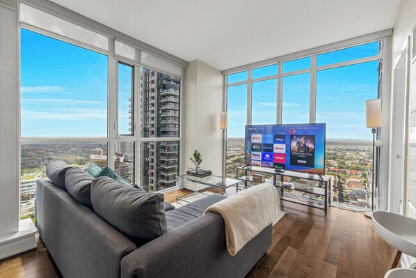 Living room with a 63” Smart TV and striking unobstructed views of Lake Ontario 