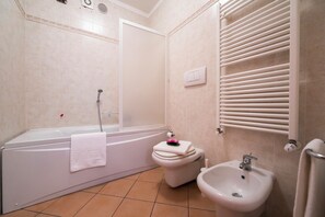 Bathroom with bathtub and handheld shower