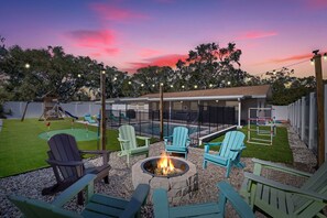Fire pit and tons of seating, in ground private heated pool with sun loungers, a fun little putting green, a playset for the kids, BBQ grill and outdoor dining