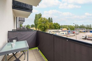A private balcony with a small table and chairs, offering a relaxing outdoor space with scenic views.


