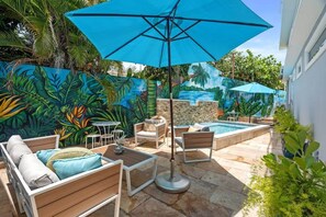 The shared outdoor terrace next to the pool is the perfect gathering place. It features lounge seating for 4 and a table for 2.