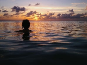 Swimming at sunset at the beach by the house