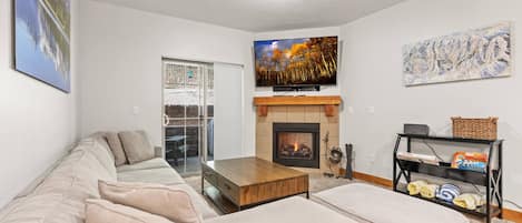 Bear Hollow Lodges 4203: This cozy condo has a warm and inviting design, with a spacious sectional sofa and a tiled corner fireplace.