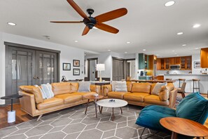 Spacious living room with two leather couches, all new furniture