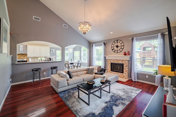 Living room with comfortable leather sofa and big screen TV with Netflix ready