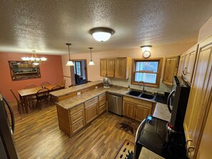 Kitchen: range, stove, fridge, microwave, dishwasher, dinnerware, pots & pans
