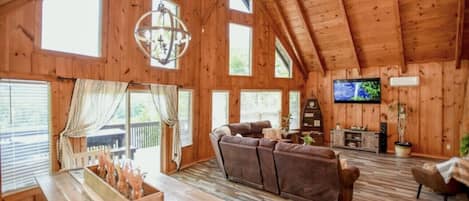 Two story windows invite loads of natural light in the great room.