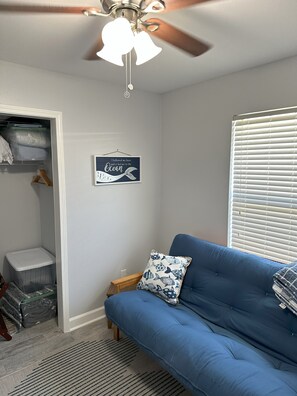 Linens and pillow in closet bins with luggage rack