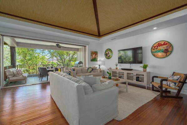 Hardwood floors, vaulted grass accented ceiling, and accent soffit lighting.