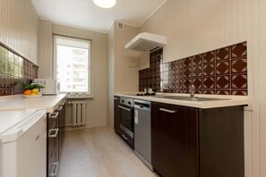 Kitchen with oven and refrigerator. 