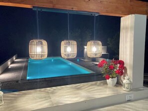 The whole pool and bar area are lit at night. 