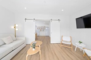 Living room with memory foam sofa bed and sliding doors for privacy