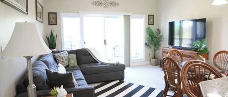 Living room with large sectional couch and smart TV