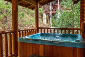 Marvel at the forest surroundings while relaxing in the luxury hot tub