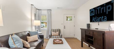 Enjoy a night of games and or TV when hanging out with family and friends on a large leather sofa and all wood flooring