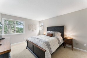 Spacious bedroom with a tv