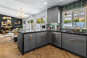 Grey cabinets and gold accents line this fabulous kitchen