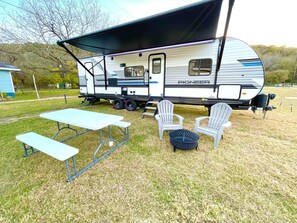 Exterior of RV - seating, charcoal grill & fire pit