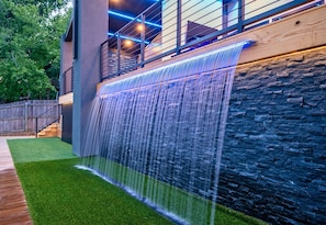 [Outdoor Area] Right Below the Massive Covered Patio, there is a Unique Splash Pad Waterfall Feature. 