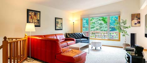 Upstairs family room with panoramic windows and walkout to the huge deck !