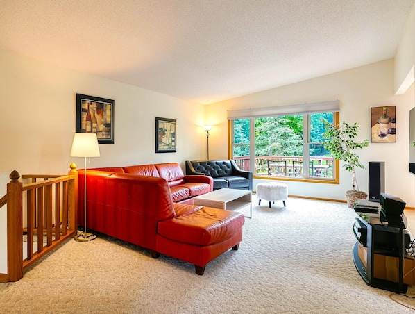 Upstairs family room with panoramic windows and walkout to the huge deck !