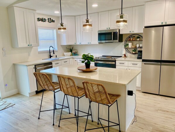 Newly remodeled kitchen open to dining room and fenced back yard BBQ+firepit 

