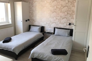 2x single beds with each having their own wardrobe.
Also there is a dressing table and Tv in the room.