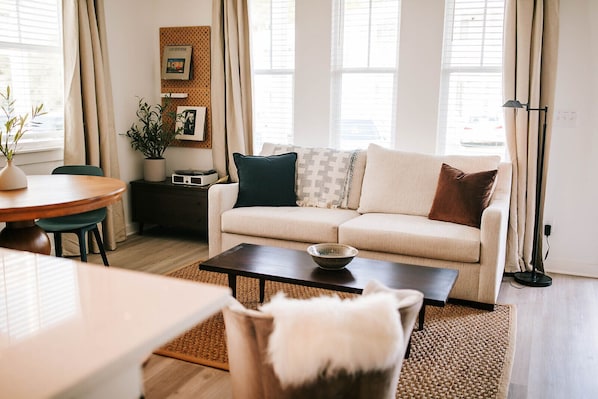 Find your peace in our beautifully designed living room, where calming ambiance meets comfort. Relax with your favorite shows on the large-screen TV or enjoy the nostalgic tunes of vinyl on our record player!