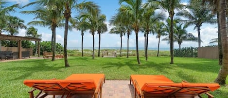 Take in the sun, beach and ocean on double chaise lounge chairs.