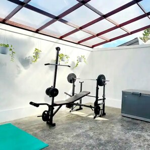 Gym area for Chest, Shoulders, Legs, and Back. Squat Rack in on the other side.