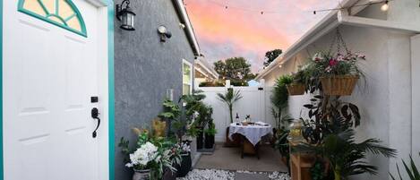 Discover your private entrance and garden courtyard dining area, lit with enchanting string lights.