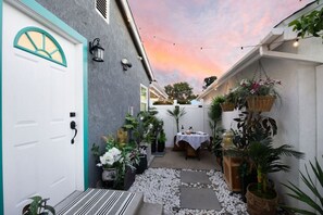 Discover your private entrance and garden courtyard dining area, lit with enchanting string lights.