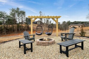 Cozy up around the wood-burning fire pit, complete with surrounding seating—perfect for evening chats, s’mores, and starry nights.