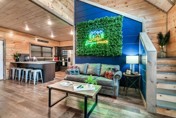 The living area leads upstairs to two spacious king bedrooms—offering comfort, privacy, and a quiet retreat after a day of fun.