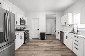 A well-appointed kitchen with a sophisticated modern design that seamlessly blends style and functionality.